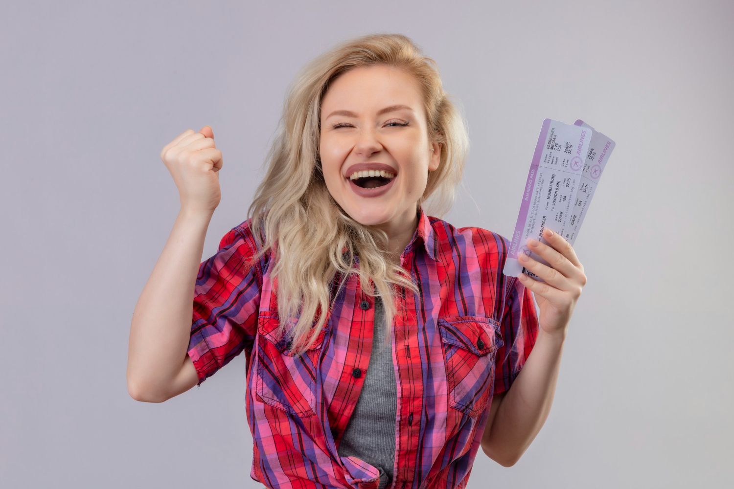a woman holding 2 tickets